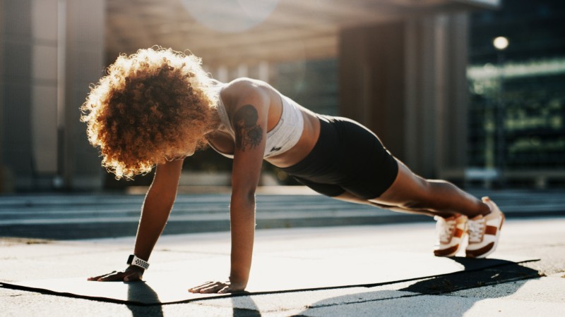 Woman doing pushups on yoga mat