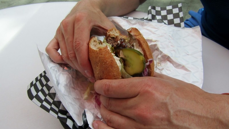 Closeup of hands holding hamburger 