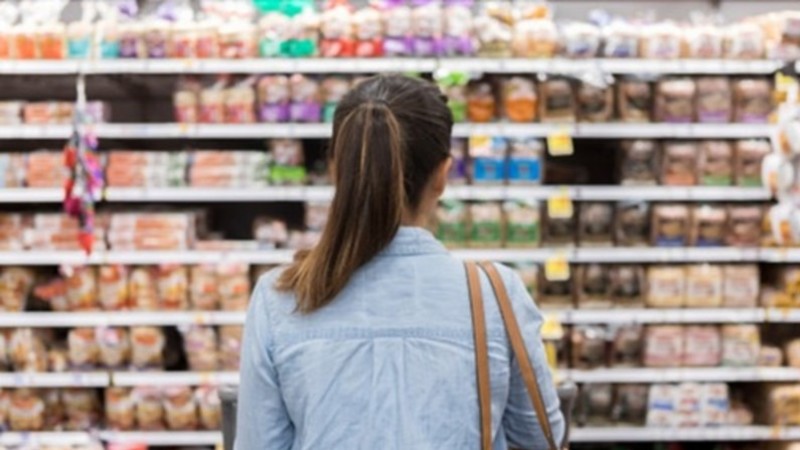 Woman pondering her grocery choices