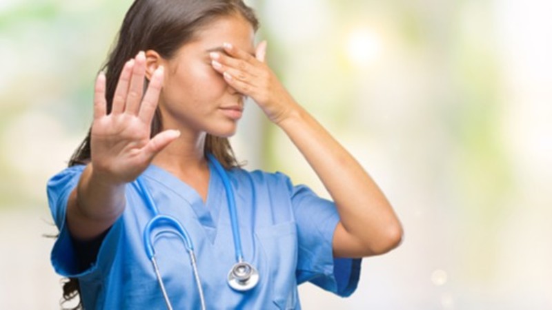 Embarrassed doctor exasperated at unhygienic health habits