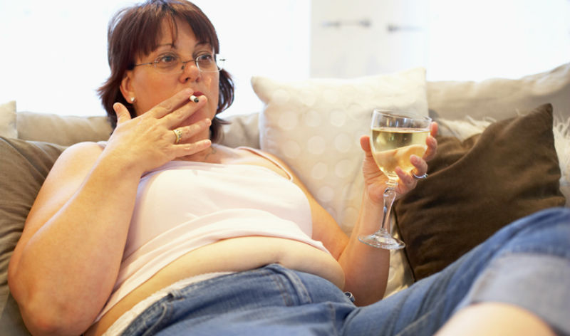 overweight woman smoking and drinking