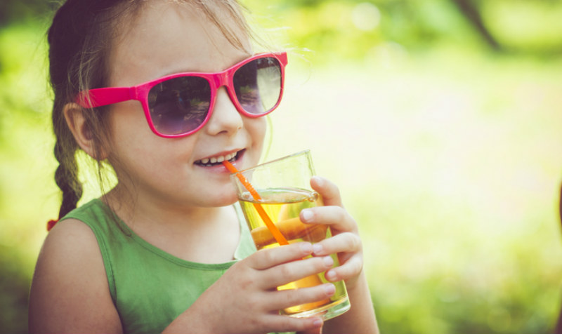 little girl drinking fruit juice
